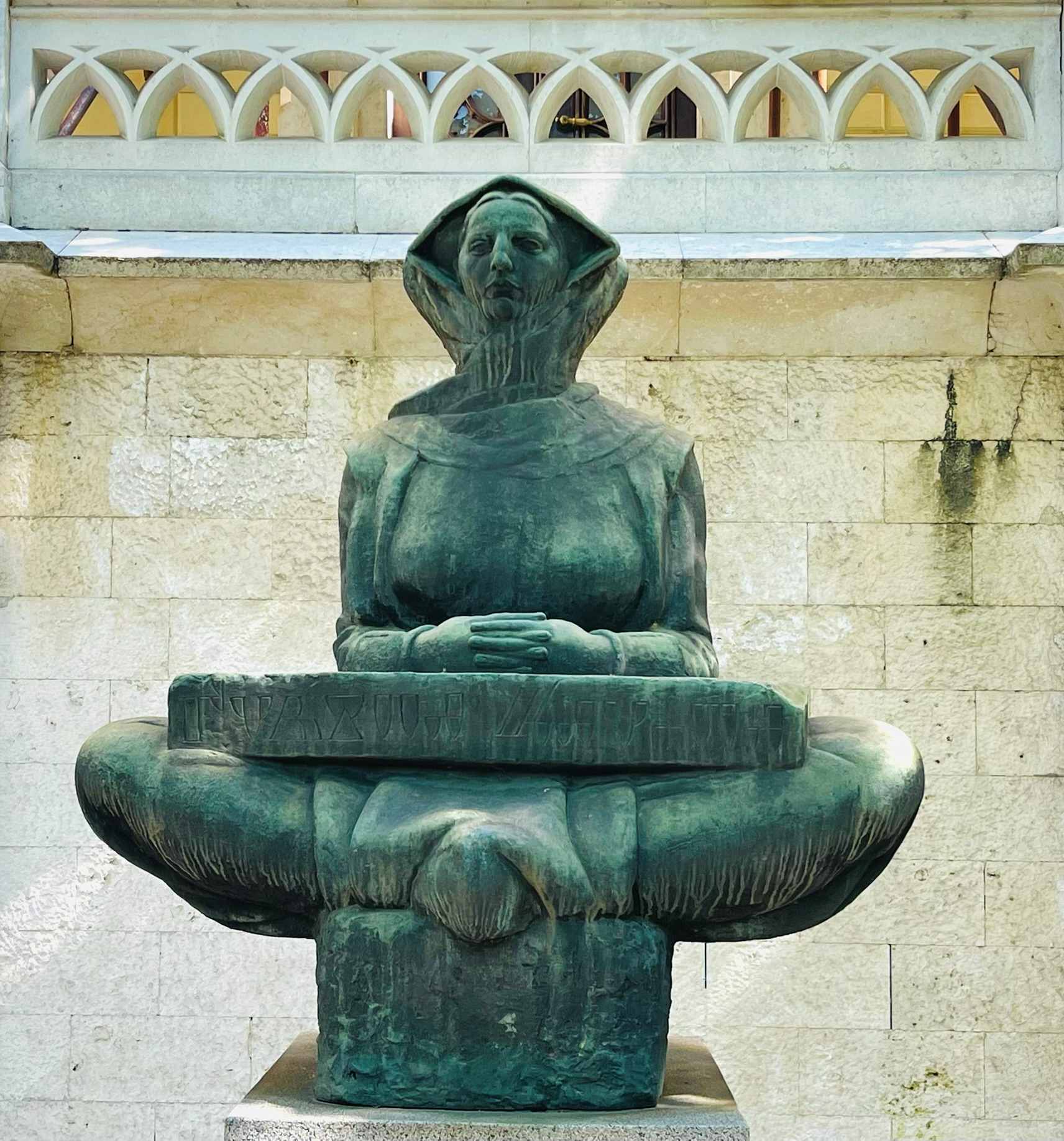 Statue of Woman with hands folded and legs crossed in Zagreb, Croatia